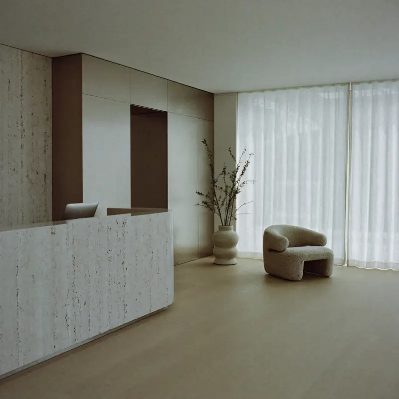 Reception in travertine and oak